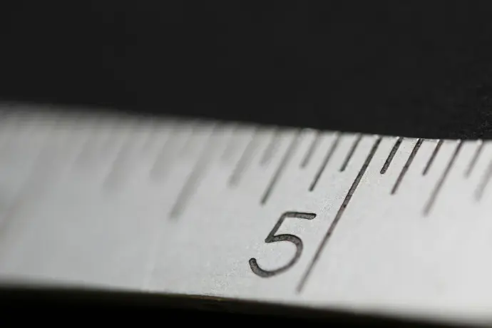 A close-up of a steel ruler, symbolizing the precision on-site measurement service for custom-fit Marchelulu braais.