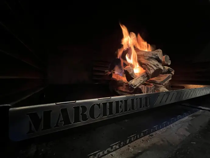 The Marchelulu V-Bucket with a roaring wood fire, fitting perfectly inside a dark built-in braai cavity in Pretoria.